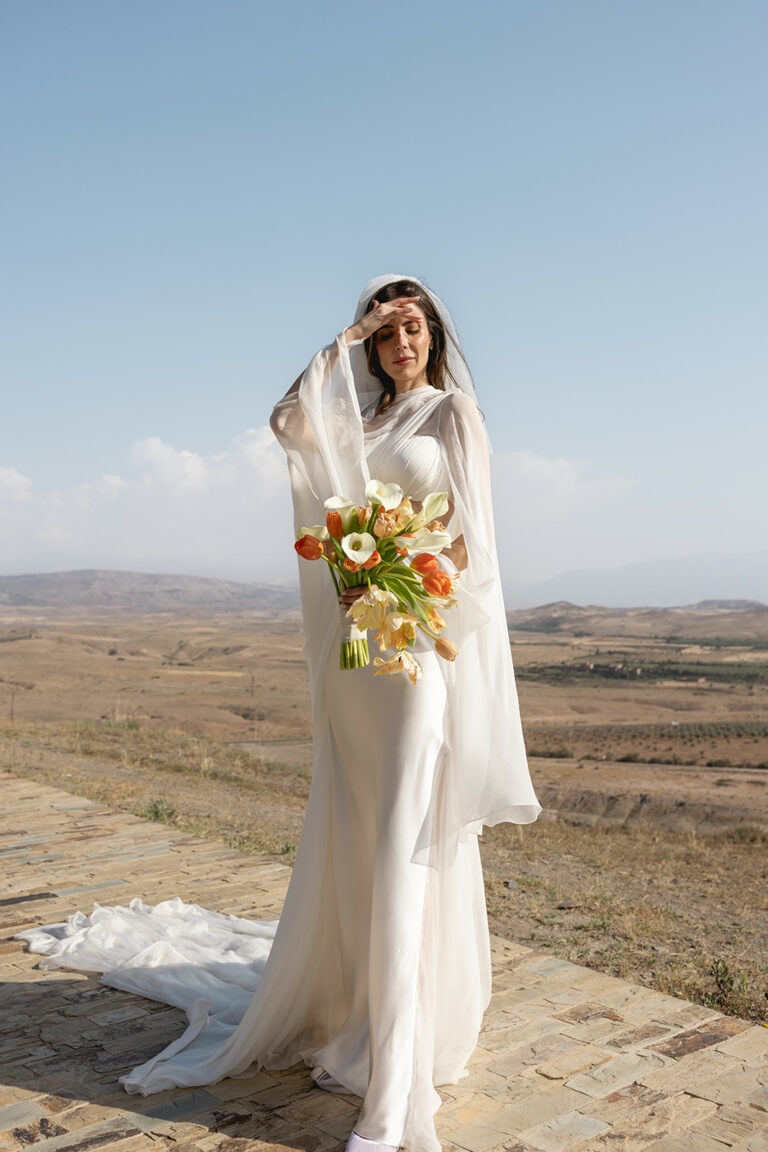 the bride standing in the kasbah d'if with the backdrop of the Atlas mountains