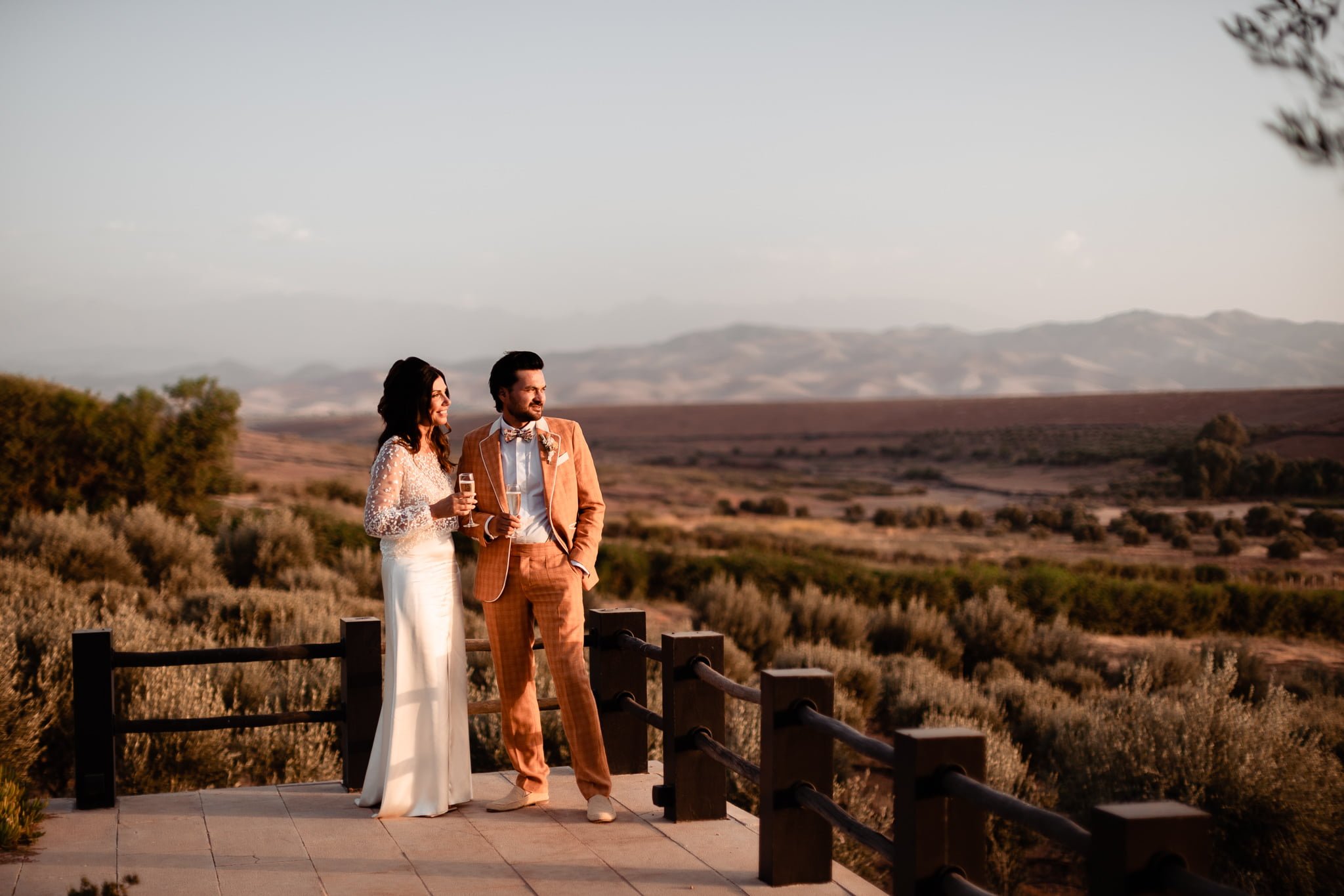 Bride and groom during chic wedding in Marrakech with the Atlas Mountains in the background