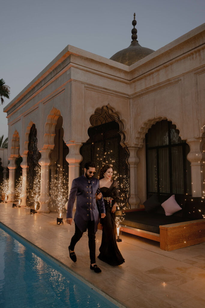 The couple walking through their venue at their Indian wedding in Marrakech www.milighoshdiaries.com